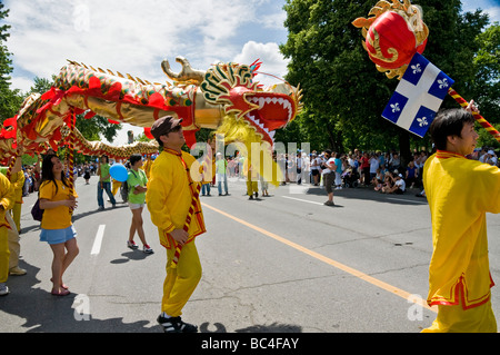 Canadians from chinese descent  parading with the traditional dragons during the Saint Jean Baptiste celebrations in Montreal Stock Photo