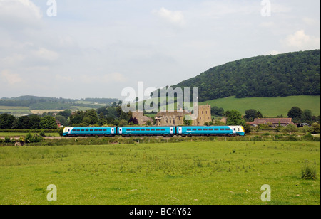 Stokesay Castle and John the Baptist Church Shropshire England UK and a Arriva passenger train passing by Stock Photo