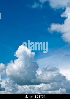 Tall cumulonimbus cloud in a vivid blue sky Stock Photo
