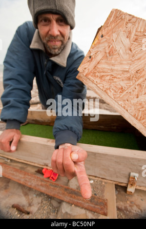 A GOLD MINER DISPLAYS A SPEC OF GOLD ON HIS FINGER TIP Stock Photo