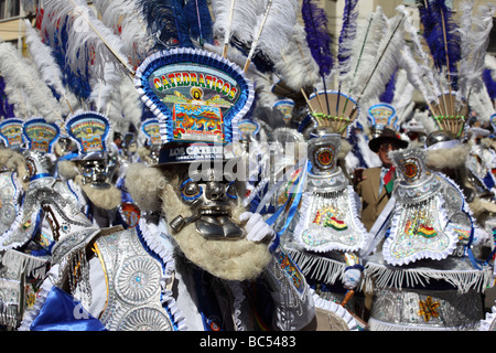 Rey moreno morenada dancers wearing silver face masks and white feather headdresses dancing at the Gran Poder festival, La Paz, Bolivia Stock Photo