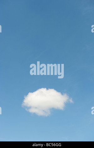 single fluffy white cloud floating alone  in a blue sky Stock Photo