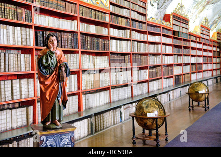 Shelves of old books in the Theological Hall of the historic Strahov Library in Prague, Czech Republic. Stock Photo