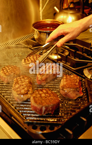 Steaks Being Prepared on a Commercial Stove Stock Photo