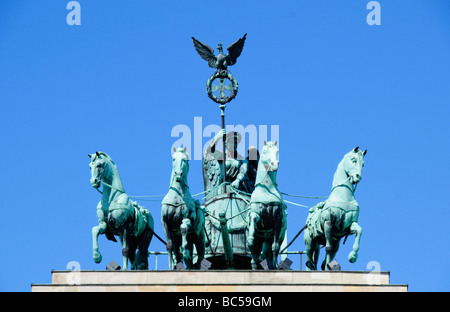 Quadriga statue of Roman Goddess of Victory, Victoria, driving a chariot with four hourses on top of the Brandenburg Gate in Berlin, Germany. Stock Photo