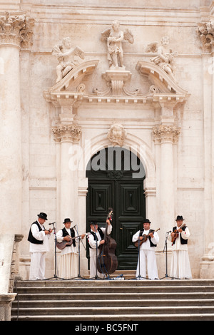 Traditional Croatian folklore group performing on the steps of the Church of St. Blaise, Dubrovnik, Croatia Stock Photo