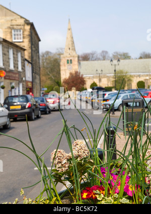 A view along Main Street towards St Lawrence's Church in the pretty village of Warkworth, Northumbria England UK Stock Photo