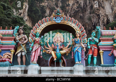 Statues of Lord Murugan and Hindu deities on top of a temple at the base of the steps at Batu Caves, Kuala Lumpur, Malaysia Stock Photo
