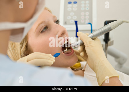 Dentist examining patient's teeth Stock Photo