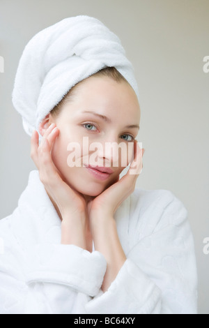 Young woman wearing towel on head, portrait Stock Photo