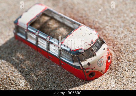 An old model  of a campervan or bus stuck in sand Stock Photo