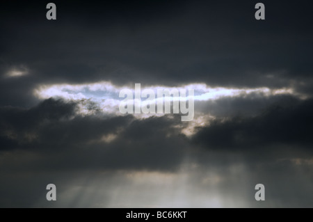 A break in the dark rain clouds Stock Photo