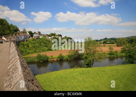 Stone bridge crossing the River Towy below the hillside town of Llandeilo Stock Photo