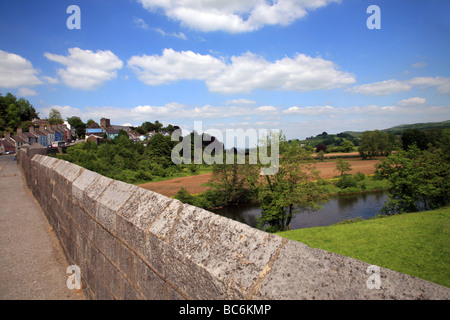 Stone bridge crossing the River Towy below the hillside town of Llandeilo Stock Photo