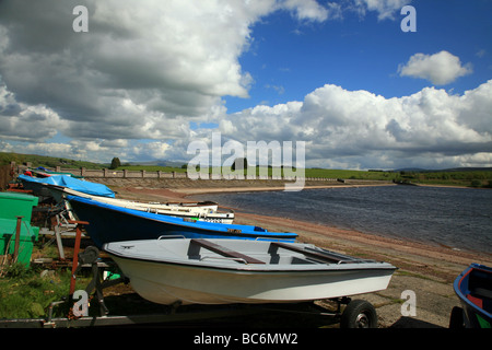Boats on the shore of the Usk Reservoir beside the dam wall. Stock Photo