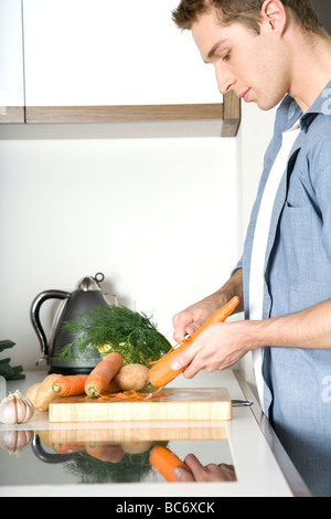 man peeling carrots Stock Photo