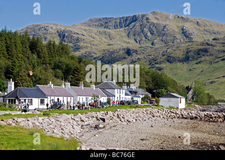 The village of Inverie in Inverie Bay Loch Nevis on Knoydart the West Highlands of Scotland with visitors at The Old Forge Pub Stock Photo