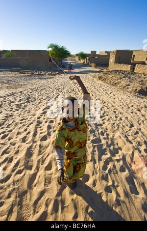 Malian Boy Pulling a Kite in Timbuktu Mali Stock Photo