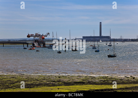 A view across the River Hamble entrance and Southampton Water to Fawley Power station in the distant Haze Stock Photo