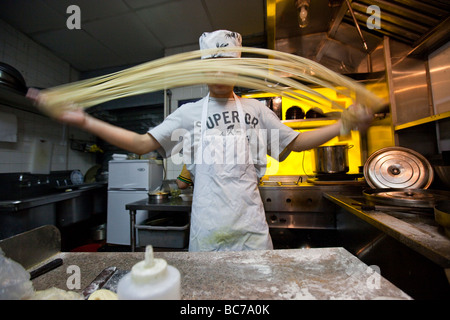 Making Handmade Noodles in a Noodle Shop in Chinatown New York CIty Stock Photo