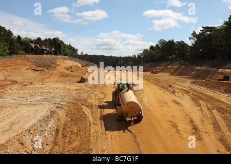 Spraying water to lay dust on the A3 Hindhead Tunnel roadworks, Surrey, looking North towards the South portal Stock Photo
