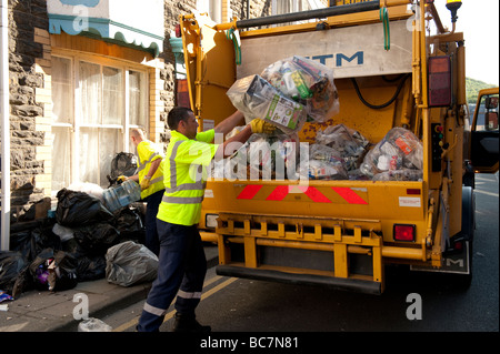 Local authority workers collecting recycling in a bag waste paper and plastic Aberystwyth Ceredigion Wales UK Stock Photo