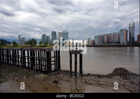 River Thames Canary Wharf Isle of Dogs Housing Offices modern London Britain apartments flats Riverside Footpath view Old wharf Stock Photo