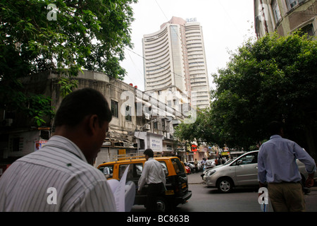 Businessmen walk on the street with the Bombay Stock Exchange (BSE) visible in the background in Mumbai in India Stock Photo