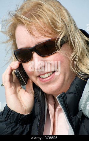 Woman speaking on a mobile phone outdoors Stock Photo