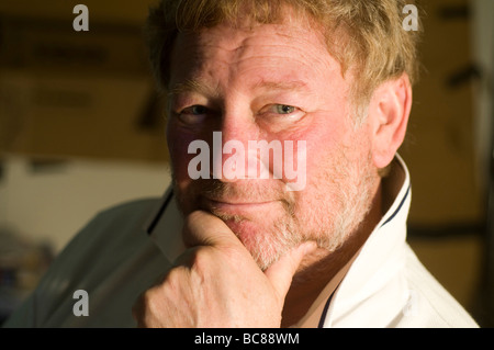 head shot portrait of handsome middle age senior man growing a beard with a smile on his face Stock Photo