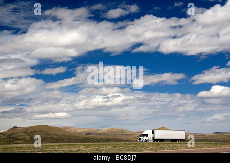 Long haul truck traveling on Interstate 80 in Carbon County Wyoming USA  Stock Photo