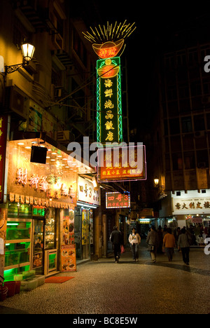 Walking street and traditional Chinese restaurant at night in Macau Stock Photo