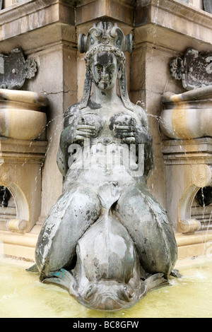 one of the four sirens with water spouting from her nipples on neptune's fountain piazza del nettuno bologna italy Stock Photo