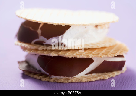 Chocolate-coated marshmallows sandwiched between wafers - Stock Photo