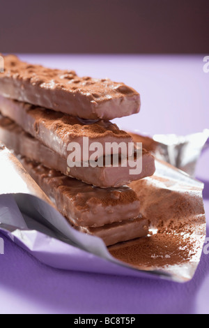 Chocolate-coated nut wafers on silver paper - Stock Photo