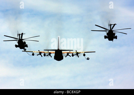 Israeli Air force Hercules C 130 transport plane refuelling two Sikorsky CH 53 helicopters in flight Stock Photo