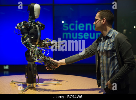BERTI  a human-sized gesturing robot built by Graham Whiteley shaking hands with a man Stock Photo