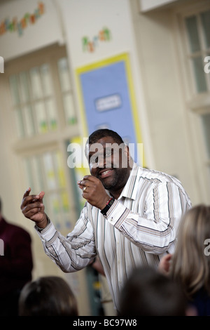 Teacher leading a game in class Music workshop Stock Photo