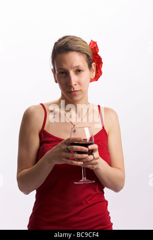 Half length portrait of a well-dressed young woman staring with a glass of wine in her hands Stock Photo