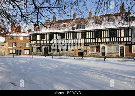 College Green and St. William's College in snow, York, England, UK Stock Photo