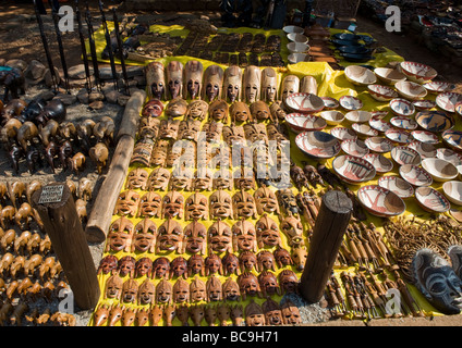 Roadside stall for tourists of hand made carvings of wildlife animals, masks, and bowels from wood of indigeneous African trees. Stock Photo