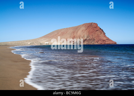 La Tejita beach and Montaña Roja (red mountain) near El Medano on Tenerife in the Canary Islands. Stock Photo