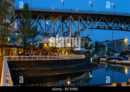 Promande and small Marina at False Creek at twilight Granville Bridge Vancouver Canada North America Stock Photo