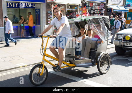 Tourists riding in a Rickshaw Central London Stock Photo