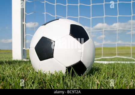 Close up of football in goal net Stock Photo