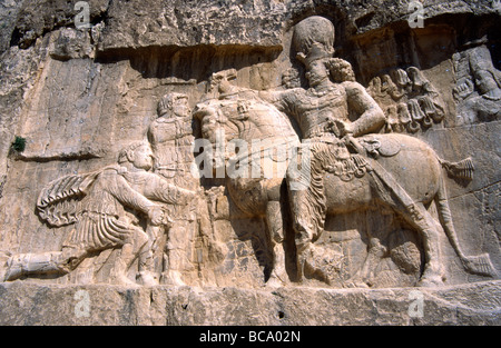 Rock relief depicting Shapur I on horseback on next to the tomb of Darius the Great at the necropolis site of Naqsh-e Rostam, near Persepolis, Iran Stock Photo