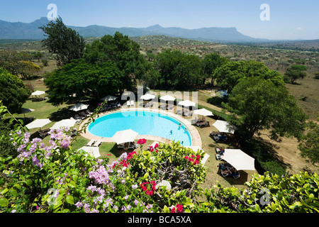 View over swimming pool of Taita Hills Lodge, Taita hills in background, Coast, Kenya Stock Photo