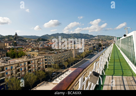 A view of the City and the mountains beyond, from the Promenade Deck of the cruise ship Oriana berthed in Messina, Sicily Stock Photo