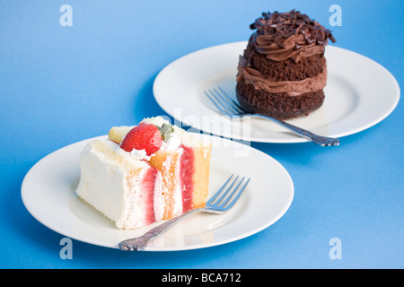 Cream cakes on a textured blue background with slight shadow Stock Photo