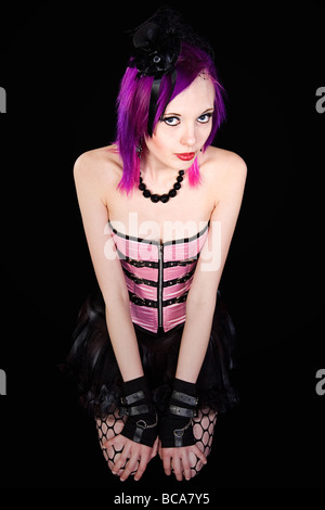 Wide Angle Shot of an Emo Girl with Purple Hair and Pink Corset Stock Photo
